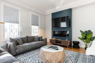 a living room with a couch and a table at Spacious & Cozy Central Cincinnati Home in Cincinnati