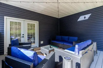 a patio with blue chairs and a table at Spacious & Cozy Central Cincinnati Home in Cincinnati