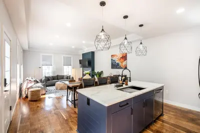 an open kitchen and living room with a couch at Spacious & Cozy Central Cincinnati Home in Cincinnati