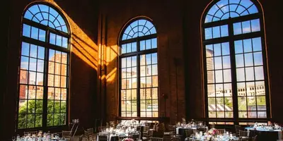 a room with many tables in a building with windows at Lofts on 4th Penthouse, Sleeps 14, 2 units in Cleveland