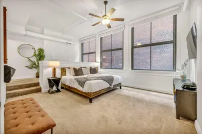 a bedroom with a bed and a ceiling fan at Lofts on 4th Penthouse, Sleeps 14, 2 units in Cleveland