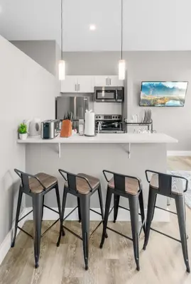 a kitchen with a table and four chairs at Modern 1 Bedroom Apartment with 2 TVs Fast WiFi and Free Parking in Cleveland