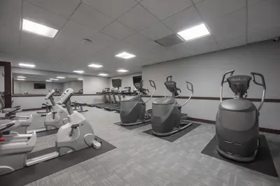 a gym with treadmills and machines in a room at Modern 1 Bedroom Apartment with 2 TVs Fast WiFi and Free Parking in Cleveland