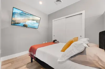 a bedroom with a bed with a painting on the wall at Modern 1 Bedroom Apartment with 2 TVs Fast WiFi and Free Parking in Cleveland