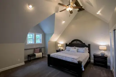 a bedroom with a bed and a ceiling fan at Sweet Private Cabin with Jacuzzi and Fire Pit in Ohio in Sugarcreek