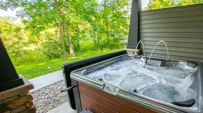 a bath tub with a sink in a backyard at Sweet Private Cabin with Jacuzzi and Fire Pit in Ohio in Sugarcreek