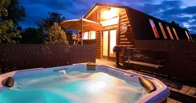 a small swimming pool in front of a tiny house at Romantic Forest Cabin with Amazing Private Deck and Spa in Ohio in Sugarcreek