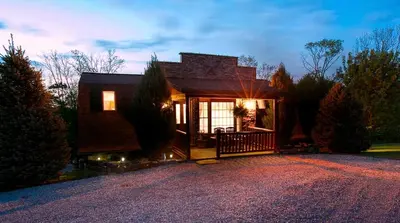 a house with a driveway in front of it at Romantic Forest Cabin with Amazing Private Deck and Spa in Ohio in Sugarcreek