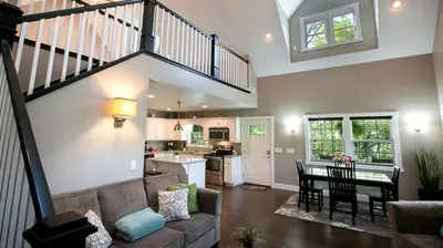 a living room with a couch and a table at Beautiful Countryside Cabin with Hot-Tub and Pond Views in Ohio in Sugarcreek