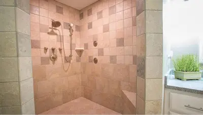 a bathroom with a shower with pink tiles at Beautiful Countryside Cabin with Hot-Tub and Pond Views in Ohio in Sugarcreek