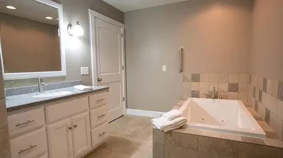 a bathroom with a tub and two sinks and a shower at Beautiful Countryside Cabin with Hot-Tub and Pond Views in Ohio in Sugarcreek