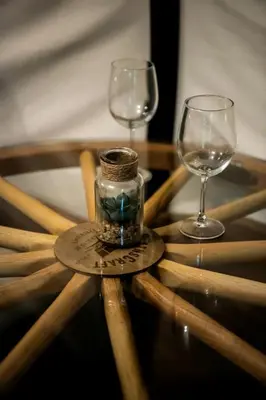 two wine glasses and a jar on a wooden table at Luxury Conestoga Wagon, Perfect for a Weekend Glamping Escape from Dayton, Ohio