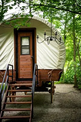 a yurt with a staircase and a door at Luxury Conestoga Wagon, Perfect for a Weekend Glamping Escape from Dayton, Ohio