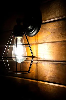 a glass lantern sitting on top of a wooden table at Luxury Conestoga Wagon, Perfect for a Weekend Glamping Escape from Dayton, Ohio