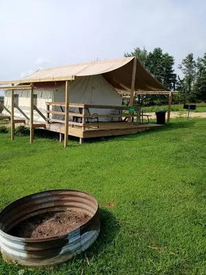 a large tent in a field with a fire pit at Impressive Tented Cabin with Peaceful Vistas and Fire Pit in Logan, Ohio in Logan