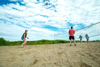 a group of people playing a game of volleyball at Breathtaking Family Friendly Tented Cabin in Logan, Ohio in Logan