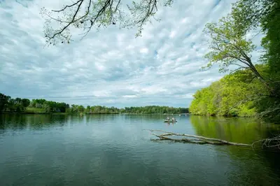 a couple of people in a boat on a river at Breathtaking Family Friendly Tented Cabin in Logan, Ohio in Logan