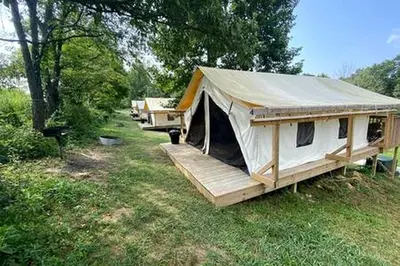 a large white tent in a field with trees at Sensational Tented Cabin Nestled Amidst Trees and Fire Pit Provided in Logan, Ohio in Logan
