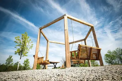 a swing set sitting on top of a hill at Cozy Tented Cabin with Fire Pit and Barbecue in Logan, Ohio in Logan