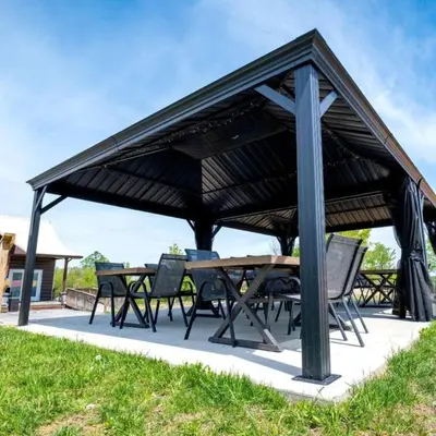 a wooden pavilion with a table and chairs at Beautiful Tented Cabin Nestled Amidst Trees with Incredible Hiking Trails Near in Logan, Ohio in Logan