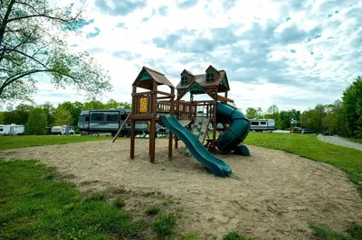 a playground with a slide in a park at Charming Tented Cabin Placed in a Selcuded Area in Logan, Ohio in Logan