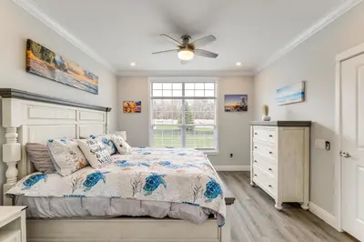 a bedroom with a bed and a ceiling fan at Furnished Screened Porch Baypoint Resort Home! in Marblehead
