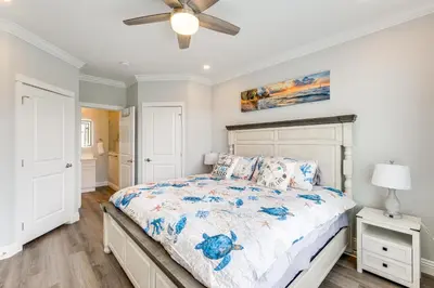 a bedroom with a bed and a ceiling fan at Furnished Screened Porch Baypoint Resort Home! in Marblehead