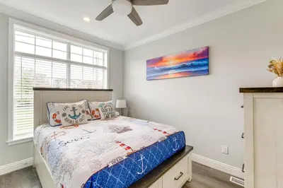 a bedroom with a bed and a painting on the wall at Furnished Screened Porch Baypoint Resort Home! in Marblehead