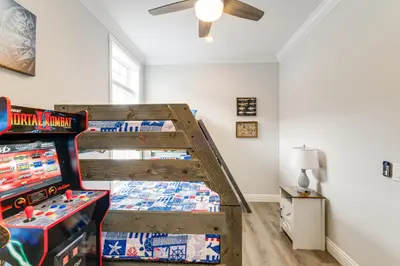 a bedroom with two bunk beds and a video game at Furnished Screened Porch Baypoint Resort Home! in Marblehead