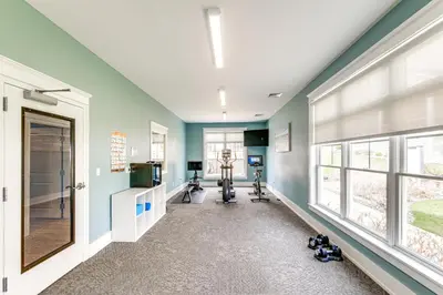 a gym with exercise equipment in a room with windows at Furnished Screened Porch Baypoint Resort Home! in Marblehead
