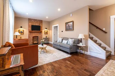 a living room with a couch and a fireplace at 4 Bedroom Luxe home in Brewery District in Columbus