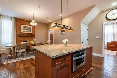 a kitchen and dining room with a table and a clock at 4 Bedroom Luxe home in Brewery District in Columbus