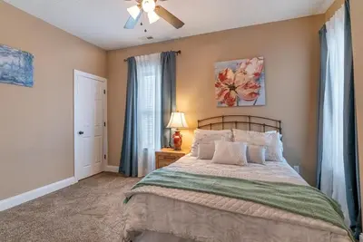 a bedroom with a bed and a ceiling fan at 4 Bedroom Luxe home in Brewery District in Columbus