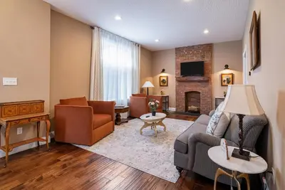 a living room with a couch and a fireplace at 4 Bedroom Luxe home in Brewery District in Columbus