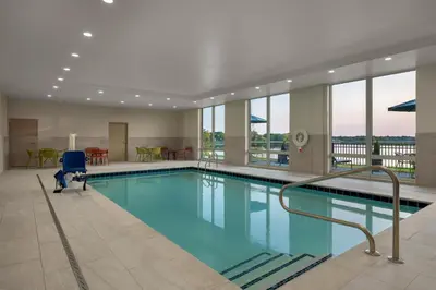 a large swimming pool in a building with windows at Hampton Inn & Suites By Hilton Port Clinton Catawba Island in Port Clinton