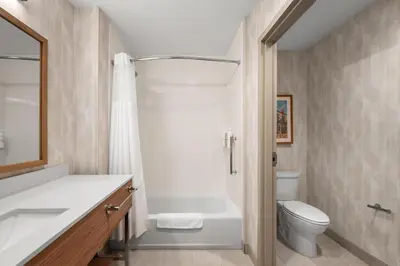 a bathroom with a tub and a toilet and a sink at Hampton Inn & Suites By Hilton Port Clinton Catawba Island in Port Clinton