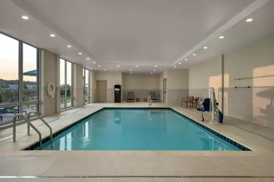 a large swimming pool in a building with windows at Hampton Inn & Suites By Hilton Port Clinton Catawba Island in Port Clinton