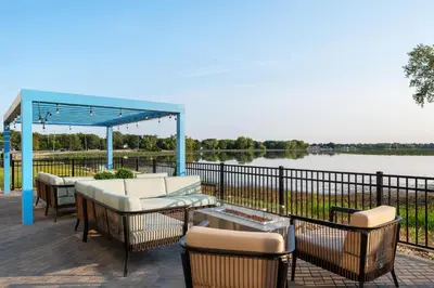 a patio with chairs and a gazebo and a lake at Hampton Inn & Suites By Hilton Port Clinton Catawba Island in Port Clinton