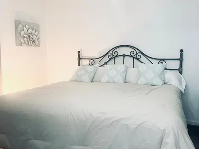 a white bed with white sheets and pillows at Retreat on Lake Milton in Berlin Center