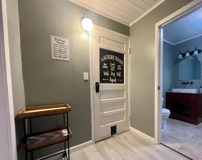 a bathroom with a toilet and a chalkboard on the wall at Retreat on Lake Milton in Berlin Center