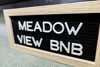 a wooden sign with the word meadow new bro at Meadow View BNB in Lima