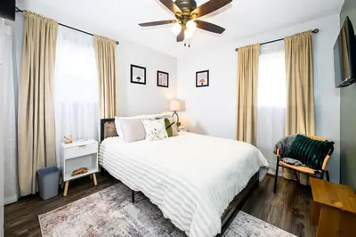 a bedroom with a bed and a ceiling fan at Meadow View BNB in Lima