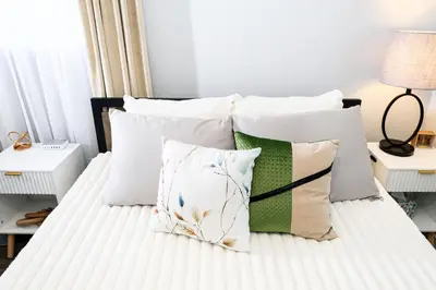 a bedroom with a bed with white sheets and pillows at Meadow View BNB in Lima