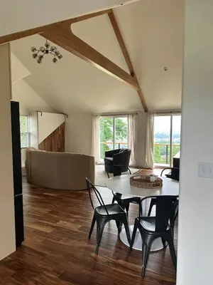 a living room with a table and chairs and a couch at Scandanavian Cottage with a View in Canonsburg