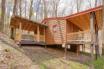 a wooden cabin in the woods with two decks at Wyandot Woods - Lake House in Laurelville