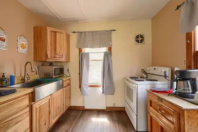 a kitchen with a sink and a stove at Wyandot Woods - Lake House in Laurelville