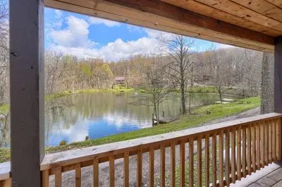 a view of a lake from the porch of a house at Wyandot Woods - Lake House in Laurelville