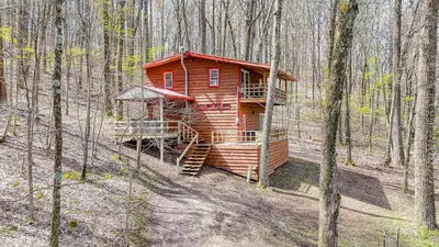 a wooden cabin in the middle of the woods at Wyandot Woods - Cedar House in Laurelville