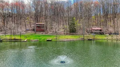 a pond with a bird in the middle of the water at Wyandot Woods - Cedar House in Laurelville