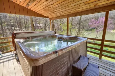 a hot tub on a porch with a wooden roof at Wyandot Woods - Hillside in Laurelville
